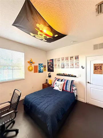 a view of a hallway with wooden floor and a living room