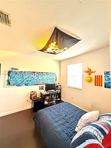 a spacious bathroom with a tub sink and mirror