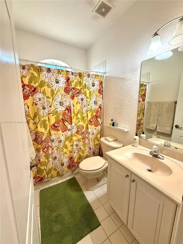 a utility room with cabinets washer and dryer