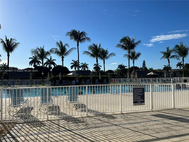 a view of yard with swimming pool and green space