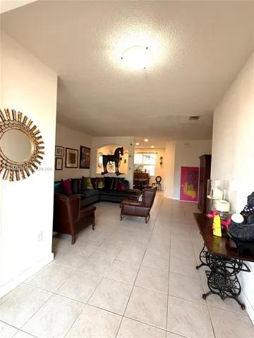 a living room with furniture and a piano