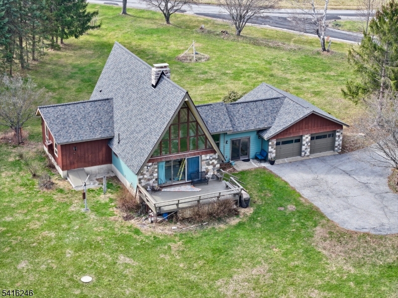 an aerial view of a house with swimming pool table and chairs