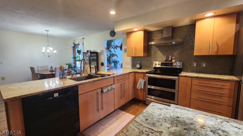156 Lott Road Wantage, NJ 07461 - Photo 23 of 44 a kitchen with stainless steel appliances kitchen island granite countertop a sink stove and cabinets