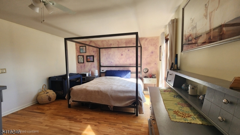 156 Lott Road Wantage, NJ 07461 - Photo 25 of 44 a bedroom with a bed and wooden floor