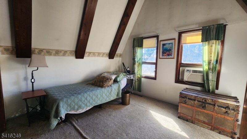156 Lott Road Wantage, NJ 07461 - Photo 30 of 44 a bedroom with a bed and a flat tv screen on dresser