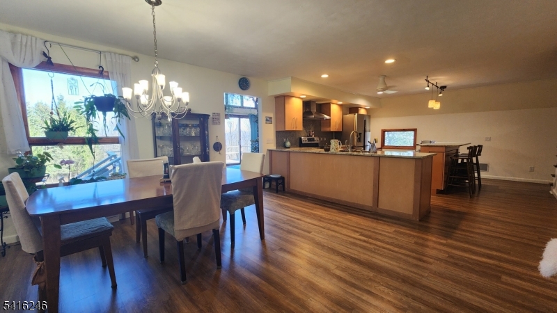 156 Lott Road Wantage, NJ 07461 - Photo 10 of 44 a dining room with furniture a chandelier and wooden floor