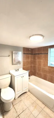a bathroom with a toilet a sink and bathtub