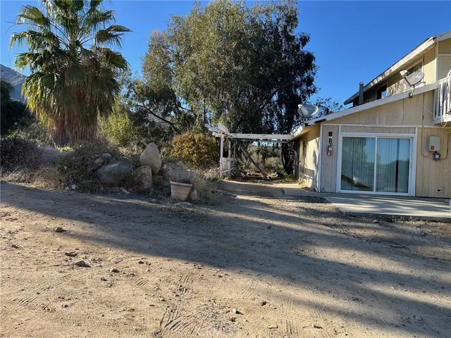 a view of a house with a yard and plant