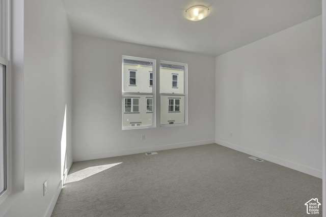 11041 South Freestone Road, Unit 130 South Jordan, UT 84009 - Photo 6 of 7 Bright room featuring light gray carpeting, white walls, and multiple windows