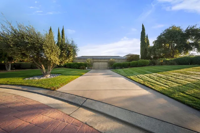 a dining hall with stainless steel appliances granite countertop a dining table and chairs with wooden floor