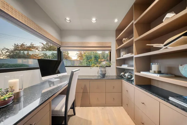 a living room with fireplace furniture and a large window