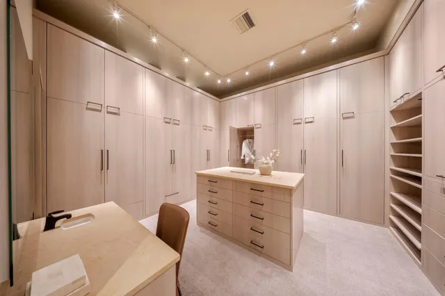 a bedroom with a bed a fireplace and a chandelier