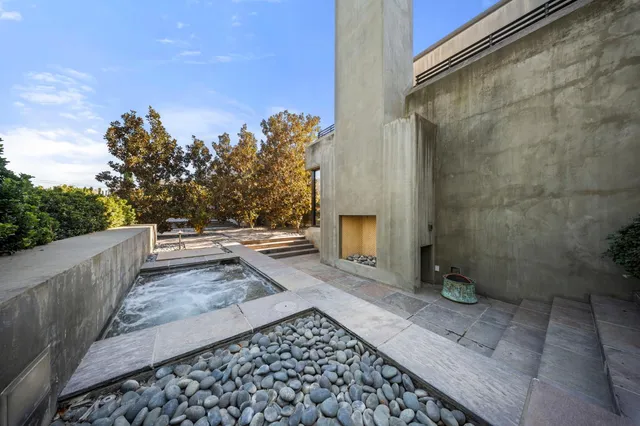 a backyard of a house with table and chairs