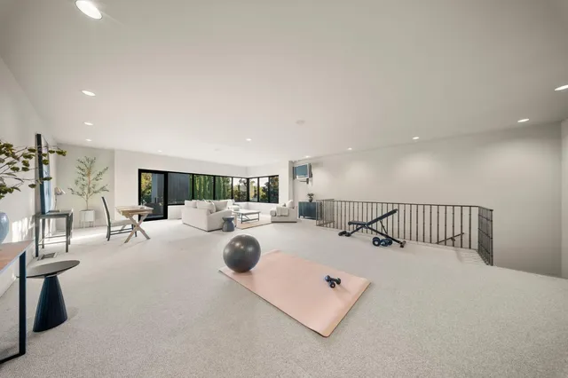 a view of a house with many windows and yard