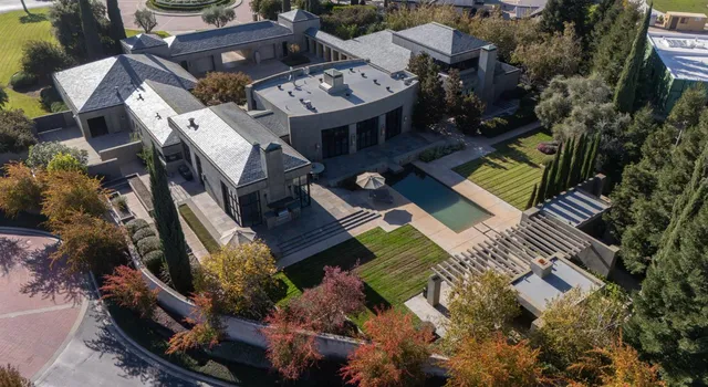 a living room with furniture large windows and a flat screen tv