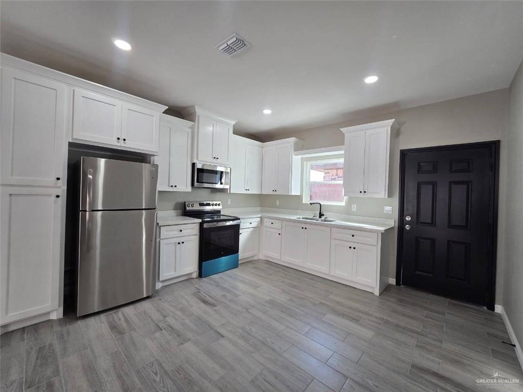1204 Cornerstone Loop Rio Grande City, TX 78582 - Photo 2 of 15 a kitchen with a refrigerator and a stove top oven