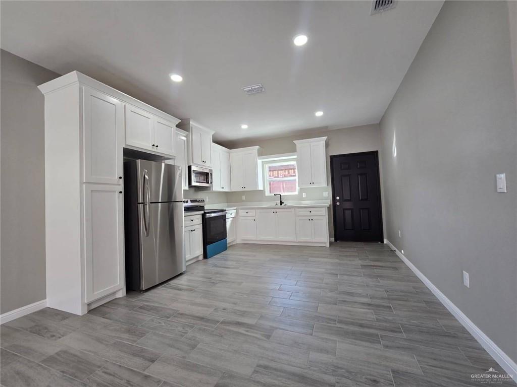 1204 Cornerstone Loop Rio Grande City, TX 78582 - Photo 3 of 15 a kitchen with refrigerator and cabinets