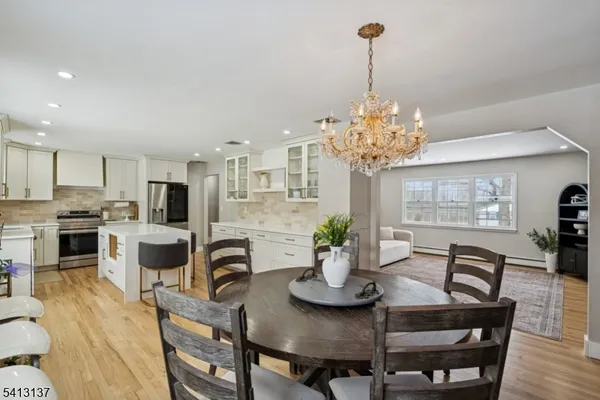 a view of a dining room with furniture and chandelier