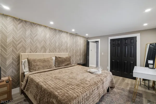 a bed sitting in a spacious bedroom next to a window