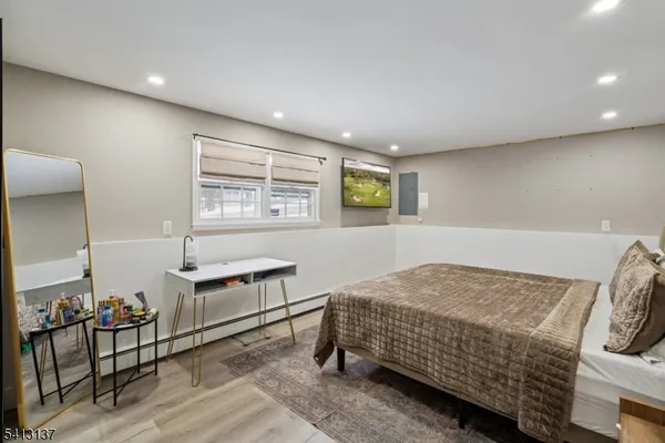 a bedroom with furniture and a window