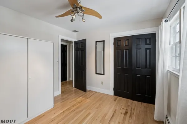 a view of hallway with wooden floor