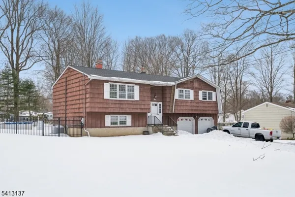 a view of a house with snow on the road