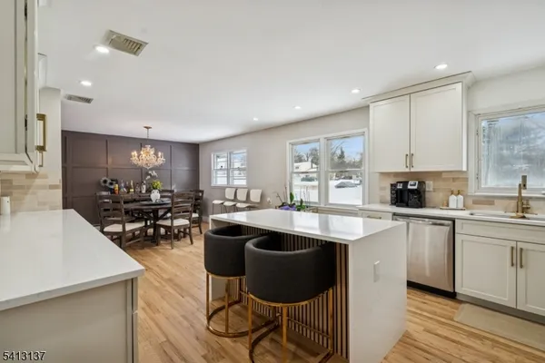 a kitchen with counter top space a sink cabinets and appliances