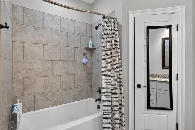 a bathroom with a bathtub and shower