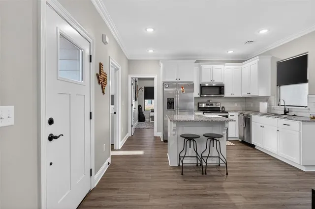a kitchen with stainless steel appliances a refrigerator stove microwave and cabinets