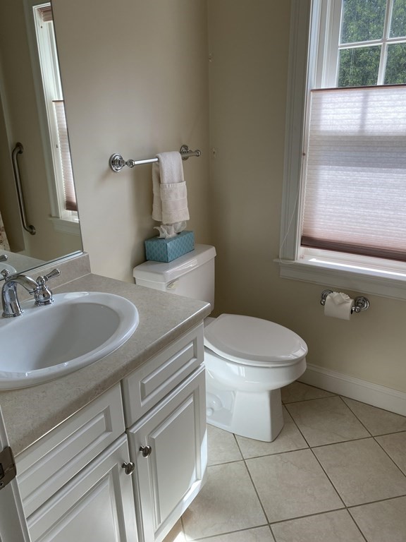 6 Essex Road, Unit 16 Ipswich, MA 01938 - Photo 12 of 14 a bathroom with a sink a toilet and a mirror