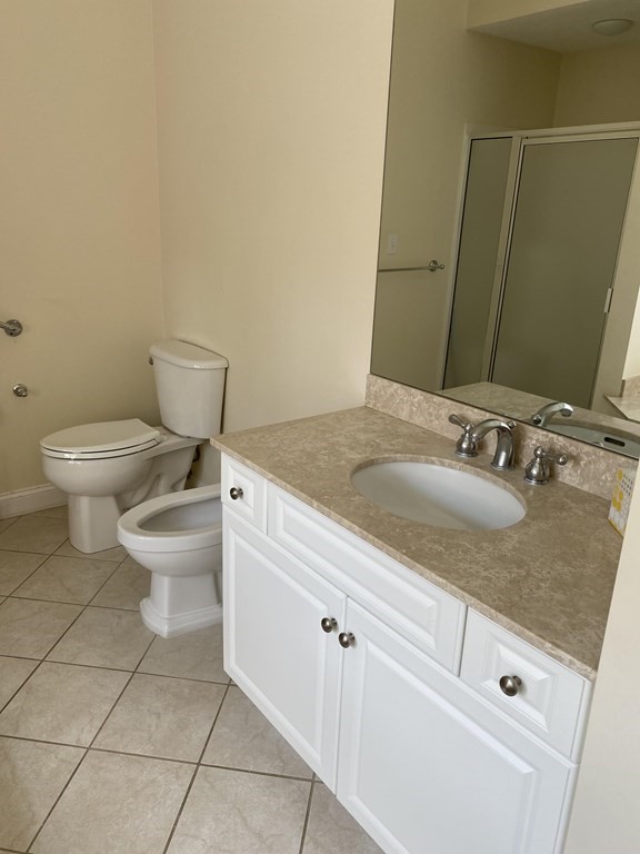 6 Essex Road, Unit 16 Ipswich, MA 01938 - Photo 9 of 14 a bathroom with a granite countertop sink a toilet and a mirror