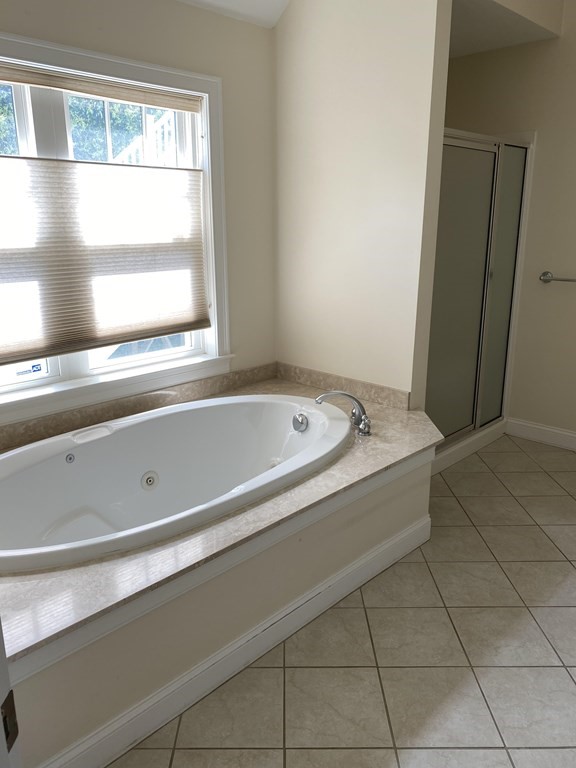 6 Essex Road, Unit 16 Ipswich, MA 01938 - Photo 10 of 14 a spacious bathroom with a bathtub and next to a window