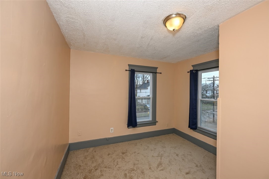 667 Elma Street Akron, OH 44310 - Photo 31 of 42 Unfurnished room with light carpet and a textured ceiling