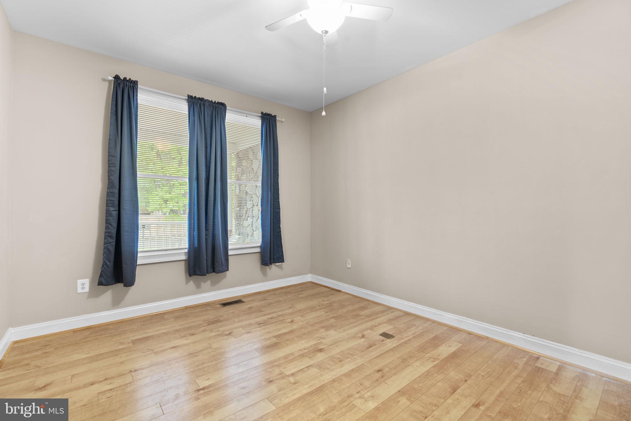 8024 Solley Road Glen Burnie, MD 21060 - Photo 45 of 83 an empty room with wooden floor and windows