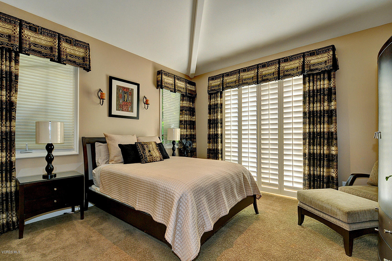 11186 Red Barn Road Camarillo, CA 93012 - Photo 18 of 41 a bedroom with a bed and a chandelier