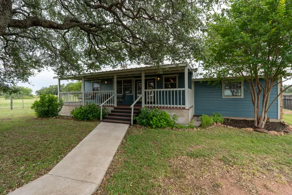 a front view of house with yard and green space
