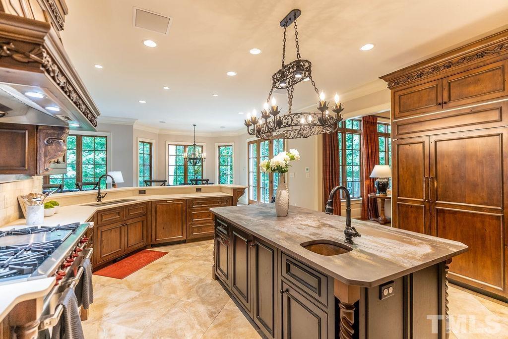 11213 Jonas Ridge Lane Raleigh, NC 27613 - Photo 13 of 100 a kitchen with stainless steel appliances granite countertop a sink a stove and a refrigerator