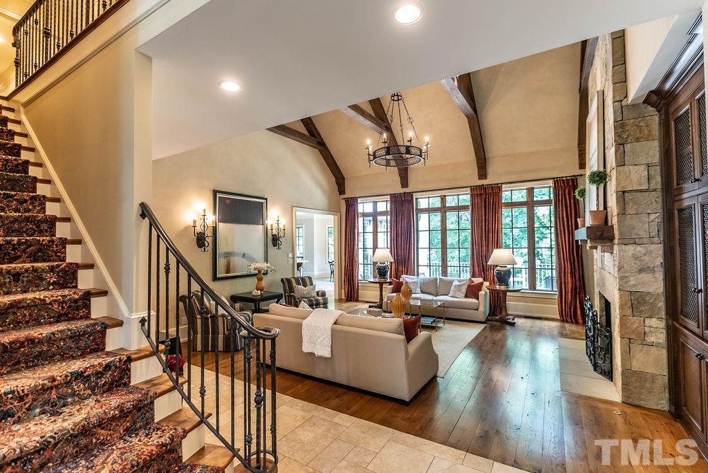 11213 Jonas Ridge Lane Raleigh, NC 27613 - Photo 21 of 100 a living room with furniture floor to ceiling windows and wooden floor