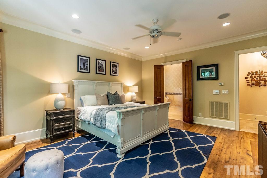 11213 Jonas Ridge Lane Raleigh, NC 27613 - Photo 24 of 100 a bedroom with a bed and wooden floor