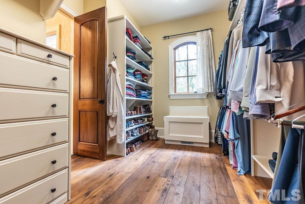11213 Jonas Ridge Lane Raleigh, NC 27613 - Photo 33 of 100 a view of walk in closet with clothes and shoes