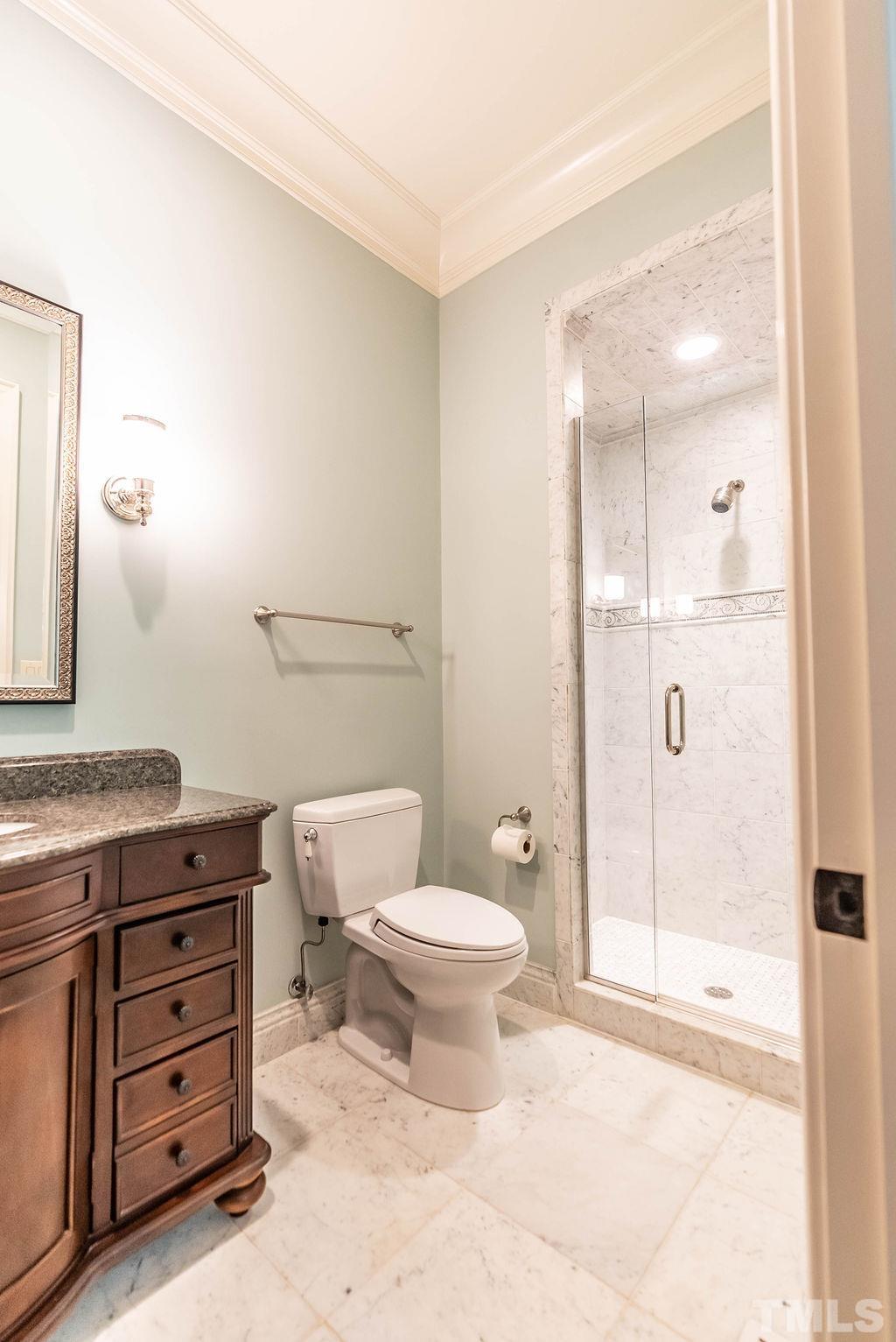 11213 Jonas Ridge Lane Raleigh, NC 27613 - Photo 41 of 100 a bathroom with a toilet a sink and shower