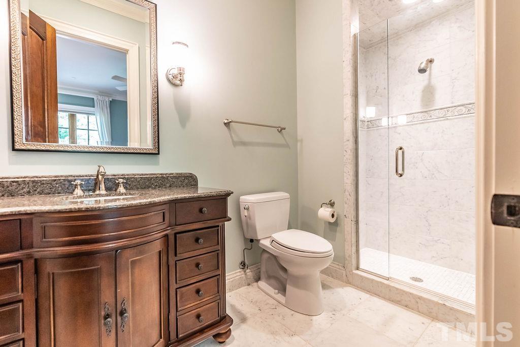 11213 Jonas Ridge Lane Raleigh, NC 27613 - Photo 42 of 100 a bathroom with a granite countertop toilet a sink and a mirror