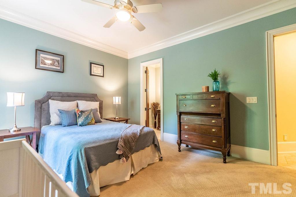 11213 Jonas Ridge Lane Raleigh, NC 27613 - Photo 44 of 100 a bedroom with a bed and a chandelier