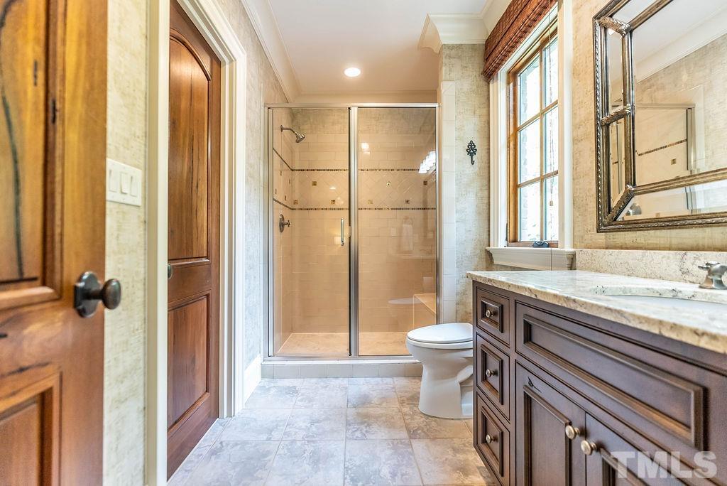11213 Jonas Ridge Lane Raleigh, NC 27613 - Photo 50 of 100 a bathroom with a granite countertop sink toilet and shower