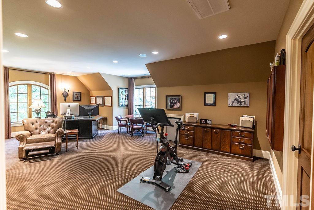 11213 Jonas Ridge Lane Raleigh, NC 27613 - Photo 63 of 100 a view of a livingroom with furniture and a flat screen tv