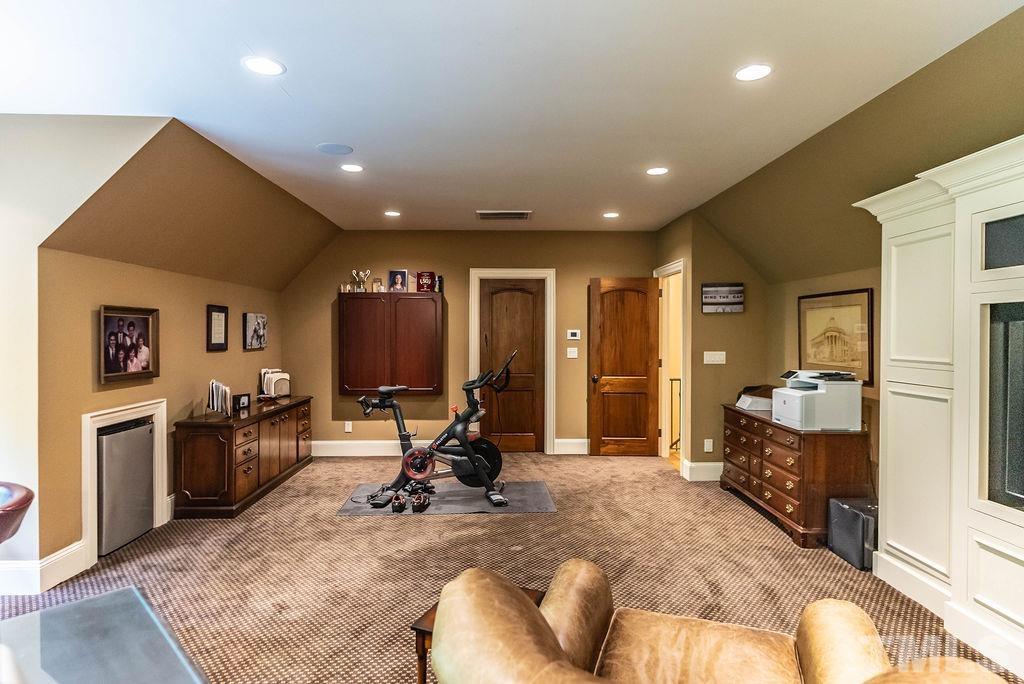 11213 Jonas Ridge Lane Raleigh, NC 27613 - Photo 65 of 100 a view of a livingroom with furniture and a flat screen tv