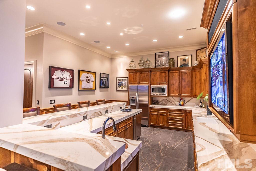 11213 Jonas Ridge Lane Raleigh, NC 27613 - Photo 66 of 100 a kitchen with stainless steel appliances kitchen island granite countertop a sink and cabinets