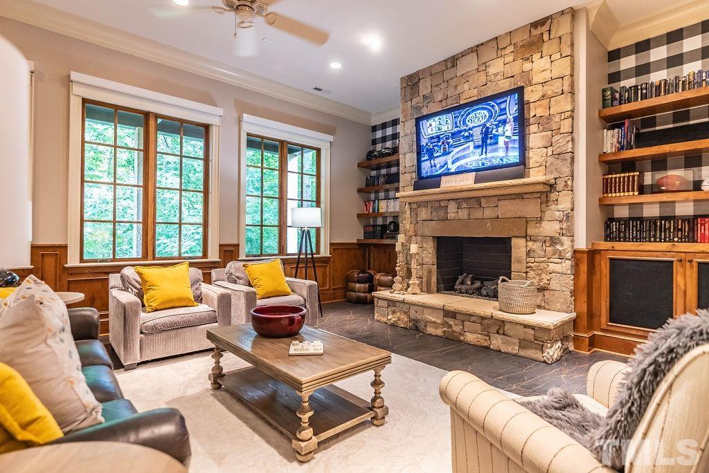 11213 Jonas Ridge Lane Raleigh, NC 27613 - Photo 71 of 100 a living room with furniture a fireplace and a large window