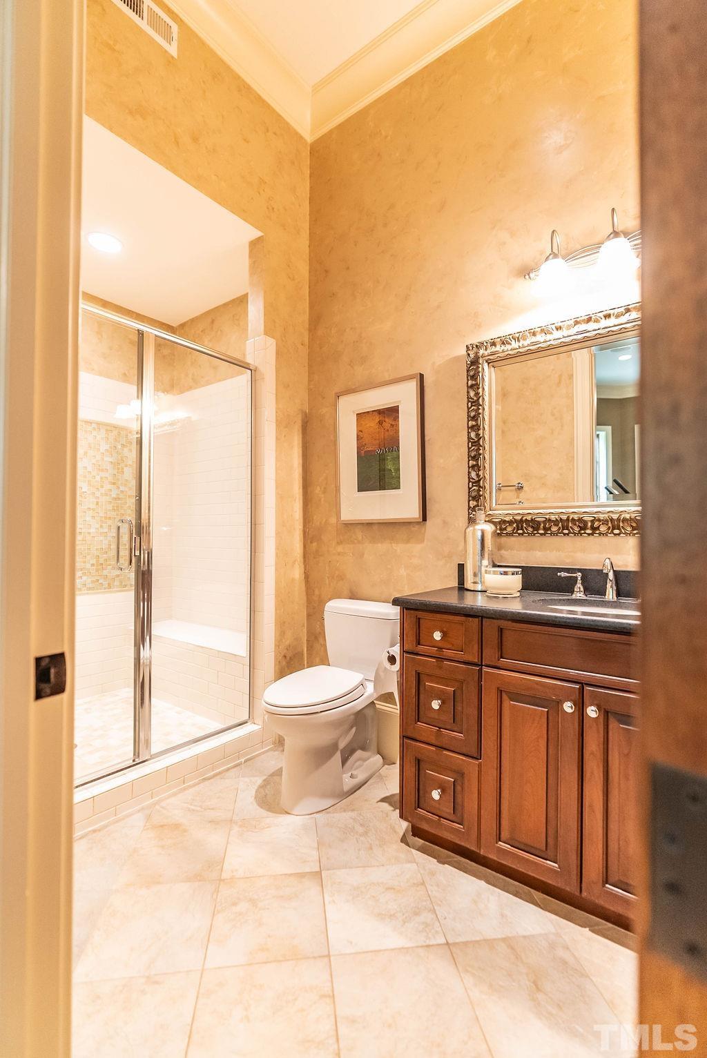 11213 Jonas Ridge Lane Raleigh, NC 27613 - Photo 80 of 100 a bathroom with a sink a toilet and a large mirror
