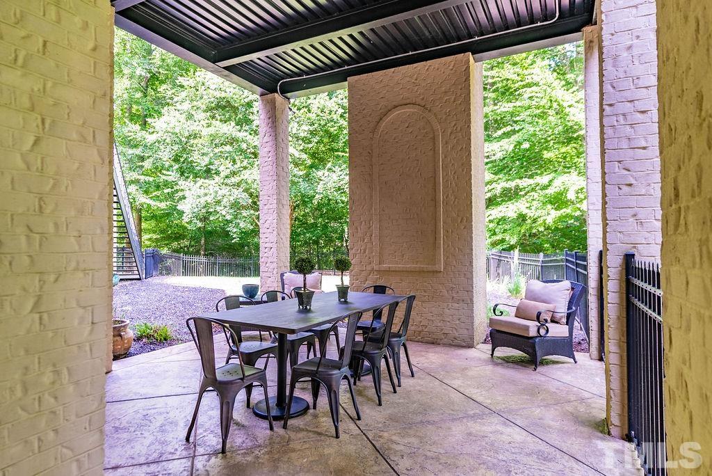 11213 Jonas Ridge Lane Raleigh, NC 27613 - Photo 84 of 100 a view of an outdoor sitting area with furniture and floor to ceiling window